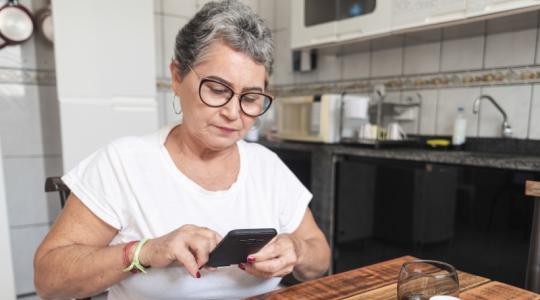 Woman testing her blood sugar at home