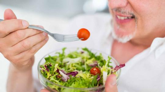 man eating salad